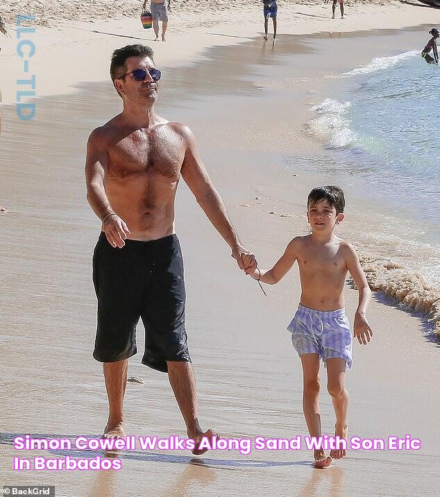 Simon Cowell walks along sand with son, Eric, in Barbados