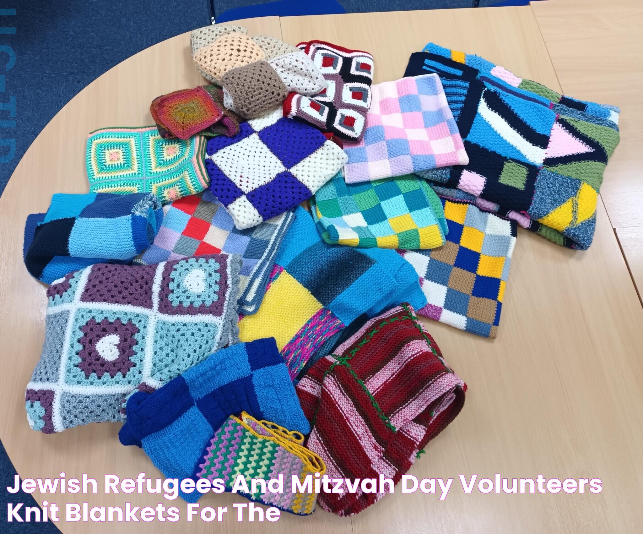 Jewish refugees and Mitzvah Day volunteers knit blankets for the