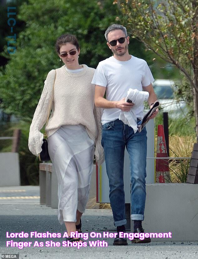 Lorde flashes a ring on her engagement finger as she shops with