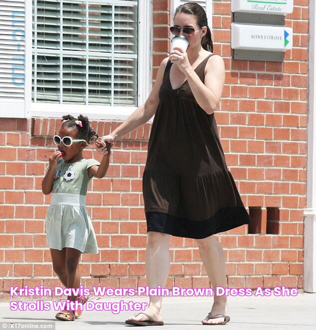 Kristin Davis wears plain brown dress as she strolls with daughter